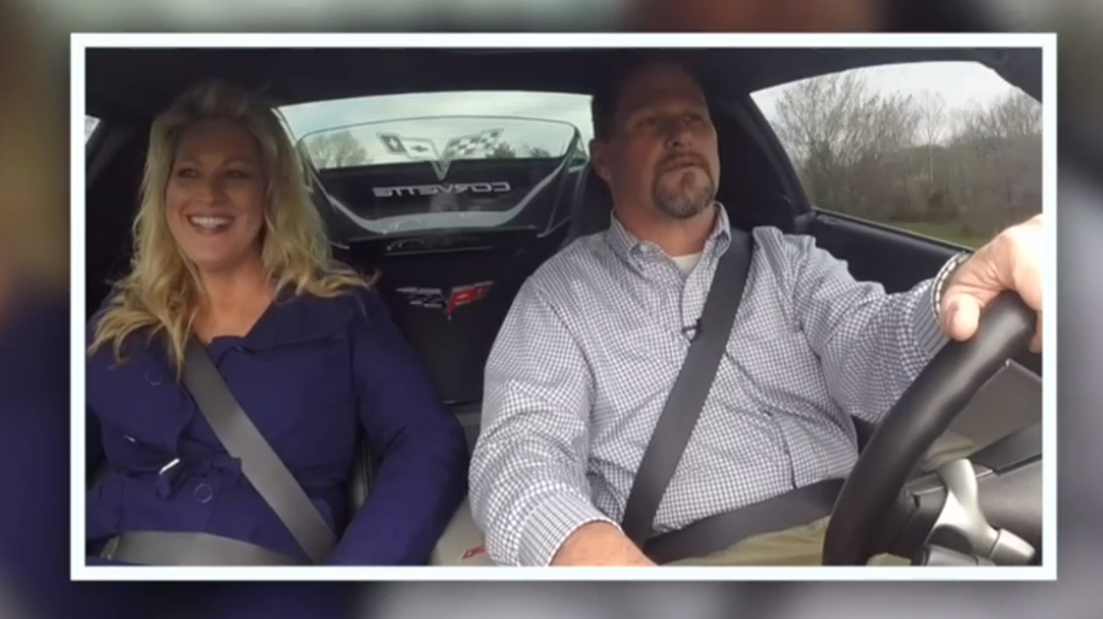 A man and woman in a Corvette