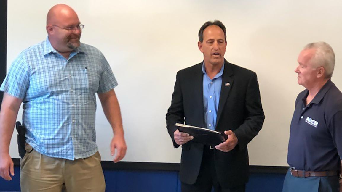 Detective J. Dickensheets (left), Director W.Woolf (center), SA J.Bettinger (right)