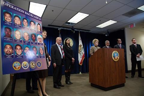 Woman speaking at a podium surrounded by coworkers